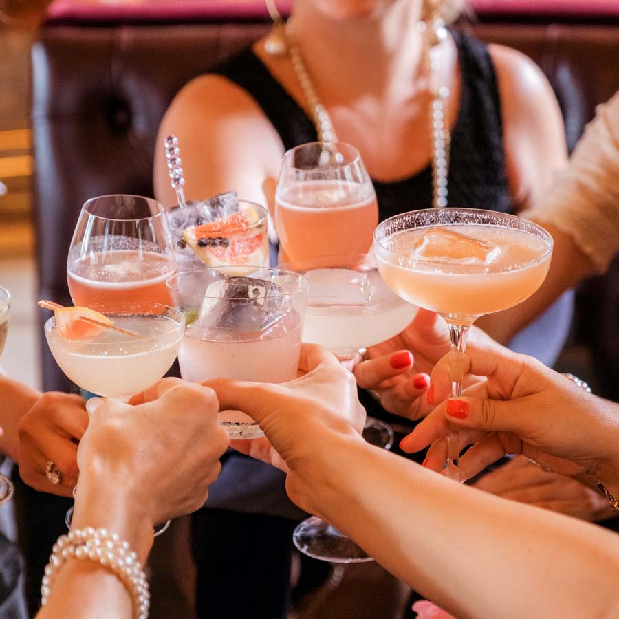 Women cheers their cocktail glasses