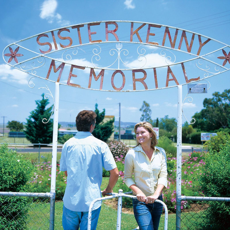 Man and Woman standing under entry sign for Sister Kenny Memorial